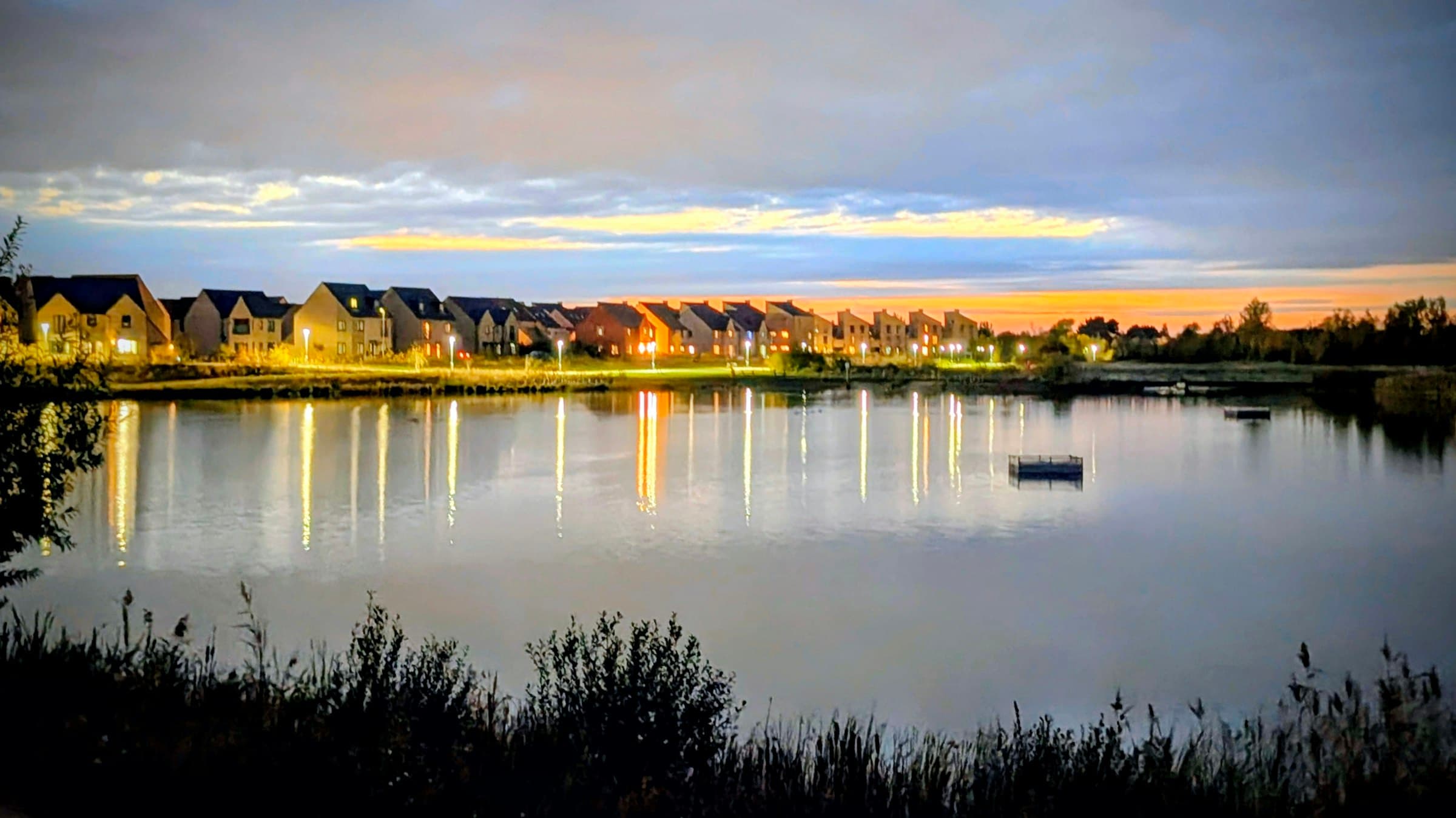 Waterfront homes at dusk (illustrative photo)